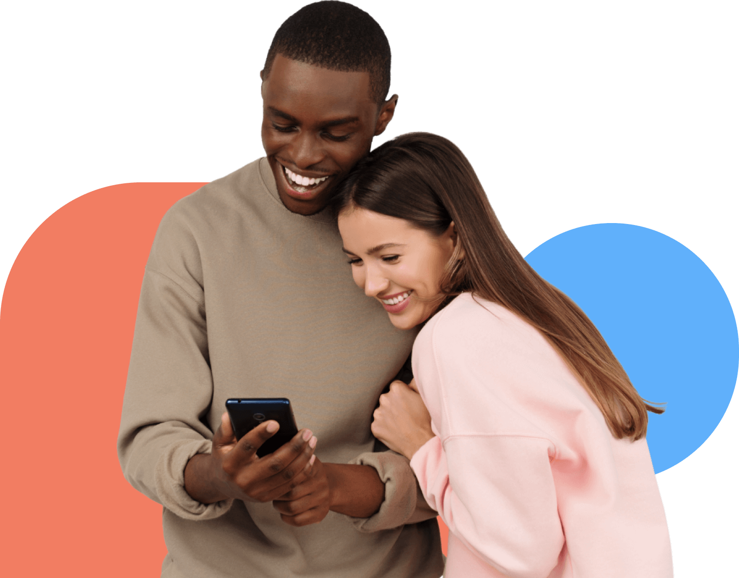 Woman embracing man, both smiling while looking at his mobile phone